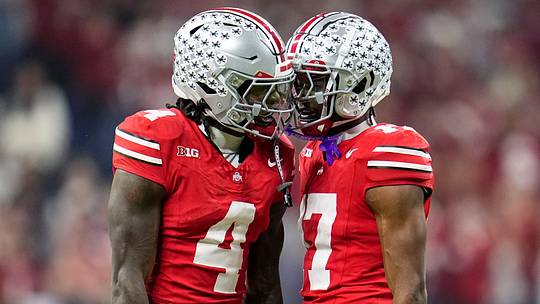 Ohio State Buckeyes wide receiver Jeremiah Smith (4) celebrates with wide receiver Carnell Tate (17) during the first half of the Big Ten Conference championship game against the Indiana Hoosiers at Lucas Oil Stadium in Indianapolis on Dec. 6, 2025.